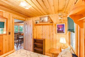 a room with wooden walls and a wooden ceiling at Waterfront Maine Vacation Rental with Private Dock in Orono
