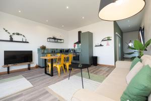 a living room with a couch and a table at The View Flat in Funchal