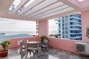 a balcony with a table and chairs and a building at Hotel Thuý Lan in Long Hai