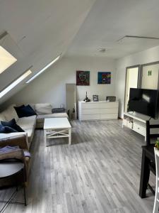 a living room with a couch and a flat screen tv at Spacious and central apartment I 250m from Bryggen in Bergen