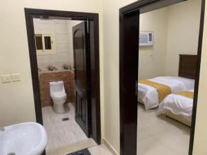 a bathroom with a sink and a toilet and a shower at شقق ضيافه خاصه 5391 in Yanbu +68 photos