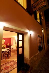 a living room with a door and a dining room at Romantico B&B in Serra SantʼAbbondio