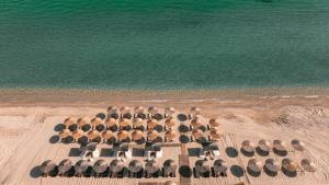an aerial view of a group of umbrellas on the beach at Acron Suites in Limenaria