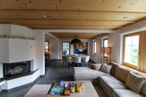 a living room with a couch and a fireplace at Chalet Badrutt by Arosa Holiday in Arosa