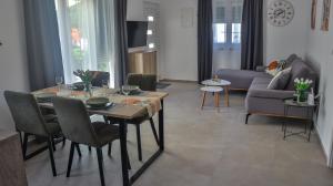 a living room with a table and a couch at Zelena oaza in Krk