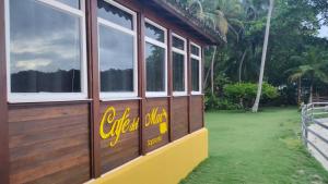 a wooden building with windows on the side of it at Cafe del Mar Sapzurro in Zapzurro