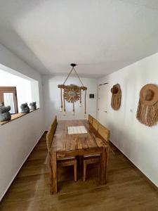 a dining room with a wooden table and chairs at House Beach in Bolonia +6 photos