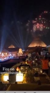 a view of a fire station at night with fireworks at Pyramids Cleopatra Apartment in Cairo