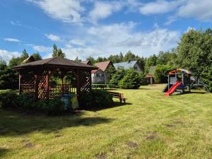 a park with a gazebo and a playground at Domki Letniskowe Bryza in Jarosławiec