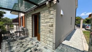 a balcony of a house with a table and chairs at Cozy Apartment Koper - New 2023 in Pobegi +1 photo