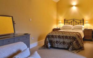a bedroom with a bed and a large mirror at Edensor Cottage Bakewell Peak District in Bakewell