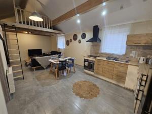 a kitchen and living room with a table and chairs at O'Pains d'Epices in Horbourg +17 photos