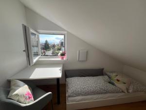 a room with a bed and a desk and a window at Eichenhöfe in Chieming