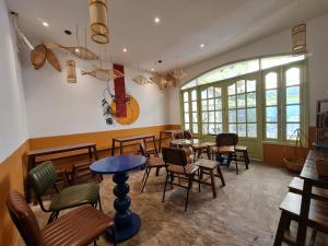 a restaurant with tables and chairs and a guitar on the wall at Myths Saigon in Ho Chi Minh City