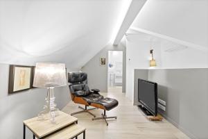 a living room with a chair and a television at Chalet au bord de l'eau in Fréjus