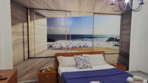 a bedroom with a bed with a view of the ocean at Casa bea in Taranto