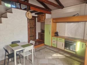 a kitchen with a table and chairs in a room at Villa Rena Agios Petros in Áyios Pétros +52 photos