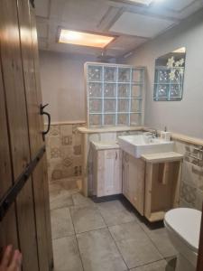 a bathroom with a sink and a toilet at Villa Rena Agios Petros in Áyios Pétros