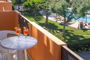a table on a balcony with two drinks on it at Portokali Apartments in Hersonissos