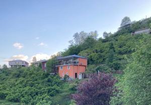 a house on the side of a hill at 8 mountains Cottage near Chakvi in Gorgadzeebi