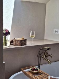 a bathroom with a sink and a glass of wine at Stone house Gazda in Omiš