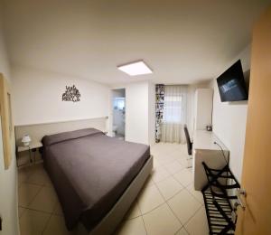 a bedroom with a bed and a desk and a television at Bed& Breakfast G&G in Porto Garibaldi +7 photos
