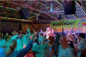 a crowd of people standing in front of a performance at CenterHillLakeCreeksideCouplesTinyCabin 2 in Smithville