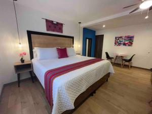 - une chambre avec un grand lit et une table avec des chaises dans l'établissement Dk4-Studio for 4 in Zona Viva, à Guatemala