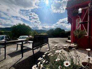 a bench sitting on the side of a building with flowers at Carra Beag Guest House in Pitlochry