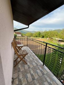 a balcony with a bench and a view of a field at Apartman Zlatija in Bajina Bašta