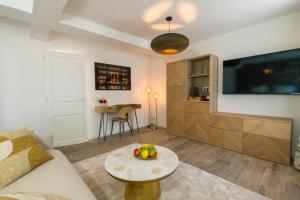 a living room with a couch and a table at Le Domaine de Darvoy in Darvoy