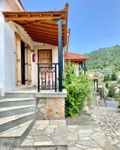 a house with a porch with a wooden roof at Betsanis Stafylos Apartments in Stafylos