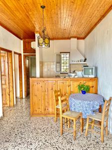 a kitchen with a table and chairs in a kitchen at Betsanis Stafylos Apartments in Stafylos