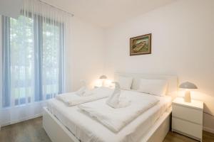 Posteľ alebo postele v izbe v ubytovaní Haven Apartman Zamárdi By BLTN
