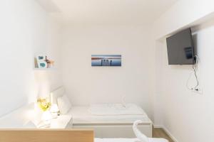 Televízia a/alebo spoločenská miestnosť v ubytovaní Haven Apartman Zamárdi By BLTN