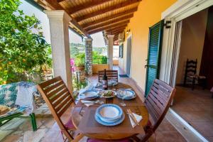 a wooden table with plates of food on a patio at Katia Apartments in Gaios +25 photos