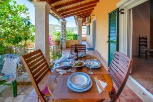 a wooden table with plates of food on a patio at Katia Apartments in Gaios