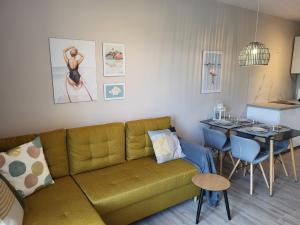 a living room with a couch and a table at NordApart Słoneczna Dolina 24 in Jastrzębia Góra