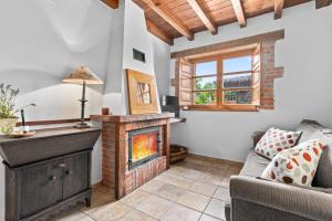 a living room with a fireplace and a couch at El Malvis in Nava