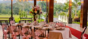 a table set up for a wedding with a vase of flowers at La Quinta de Andrés in San Isidro