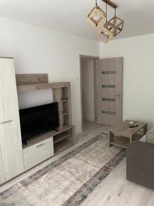 a living room with a flat screen tv on a entertainment center at Apartament Wave in Constanţa