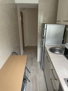 a small kitchen with a sink and a refrigerator at Apartament Wave in Constanţa