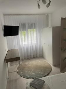 a living room with a round rug and a table at Apartament Wave in Constanţa +3 photos
