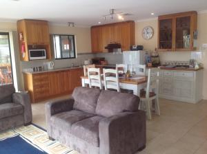 a living room with a couch and a kitchen at Breakaway Farmstay in Encounter Bay
