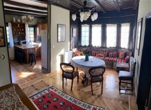 a living room with a table and a couch at Miletića čardak Ribarska Banja in Ribarska Banja