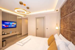 En eller flere senge i et værelse på Massimo Hotel