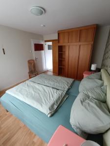 a bedroom with a large bed and a couch at Ferienunterkunft Barsinghausen in Barsinghausen