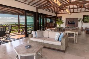 a living room with a couch and a table at Manacá Pousada Parque in Arraial d'Ajuda