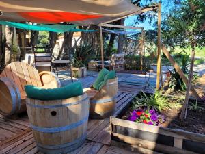 a patio with wooden chairs and an umbrella at gites du mas Donat in Perpignan +58 photos