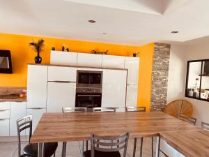 a dining room with a table and chairs at Chambre mer in Orgères